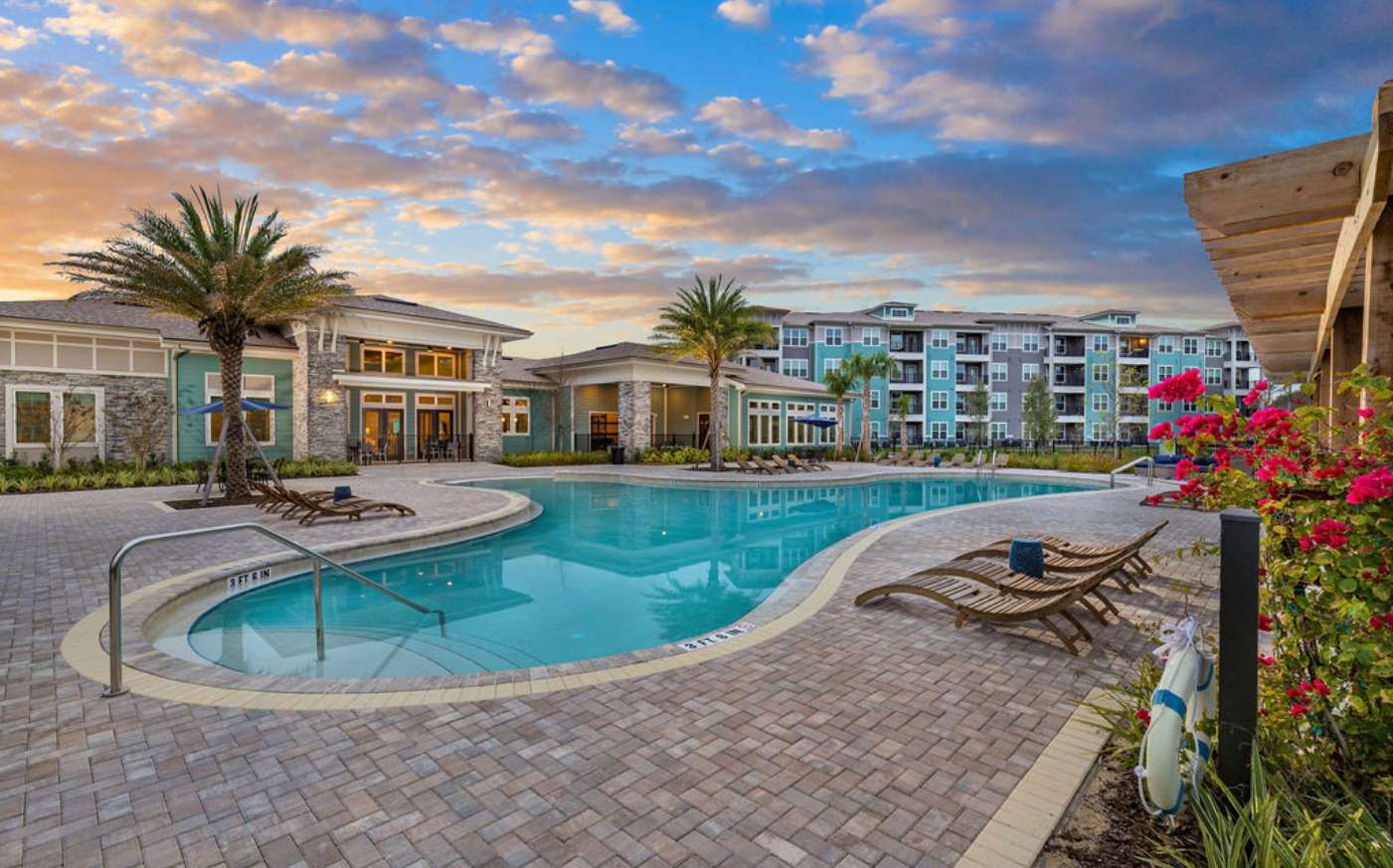 Luxury pool in a courtyard behind a new build apartment community